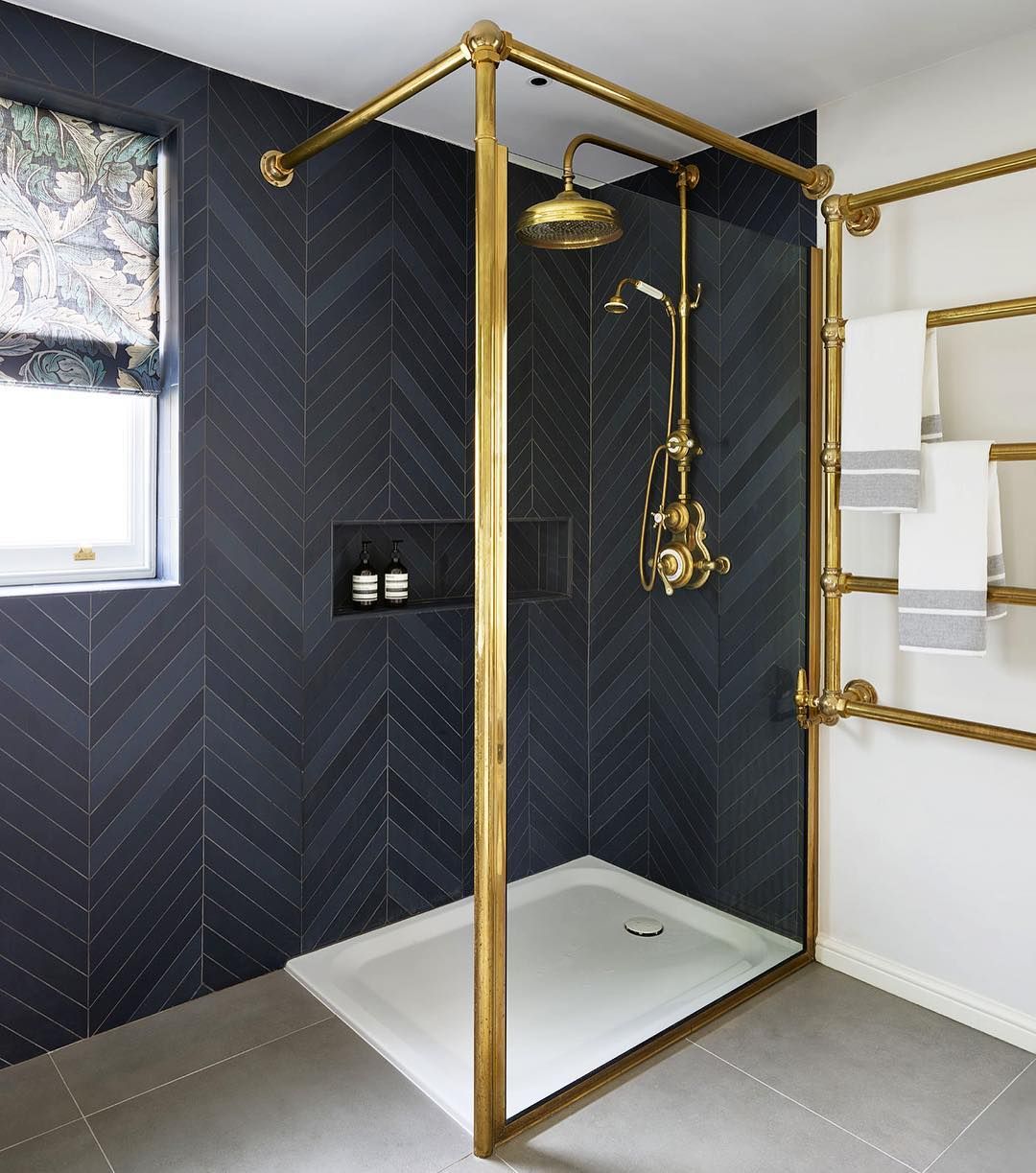 Bathroom with Black Herringbone tiles on wall via @drummonds_bathrooms